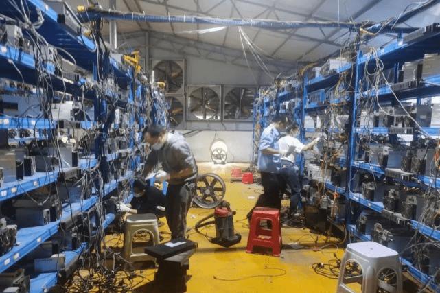 A picture showing a mining farm with rows of mining rigs, emphasizing the scale and infrastructure.